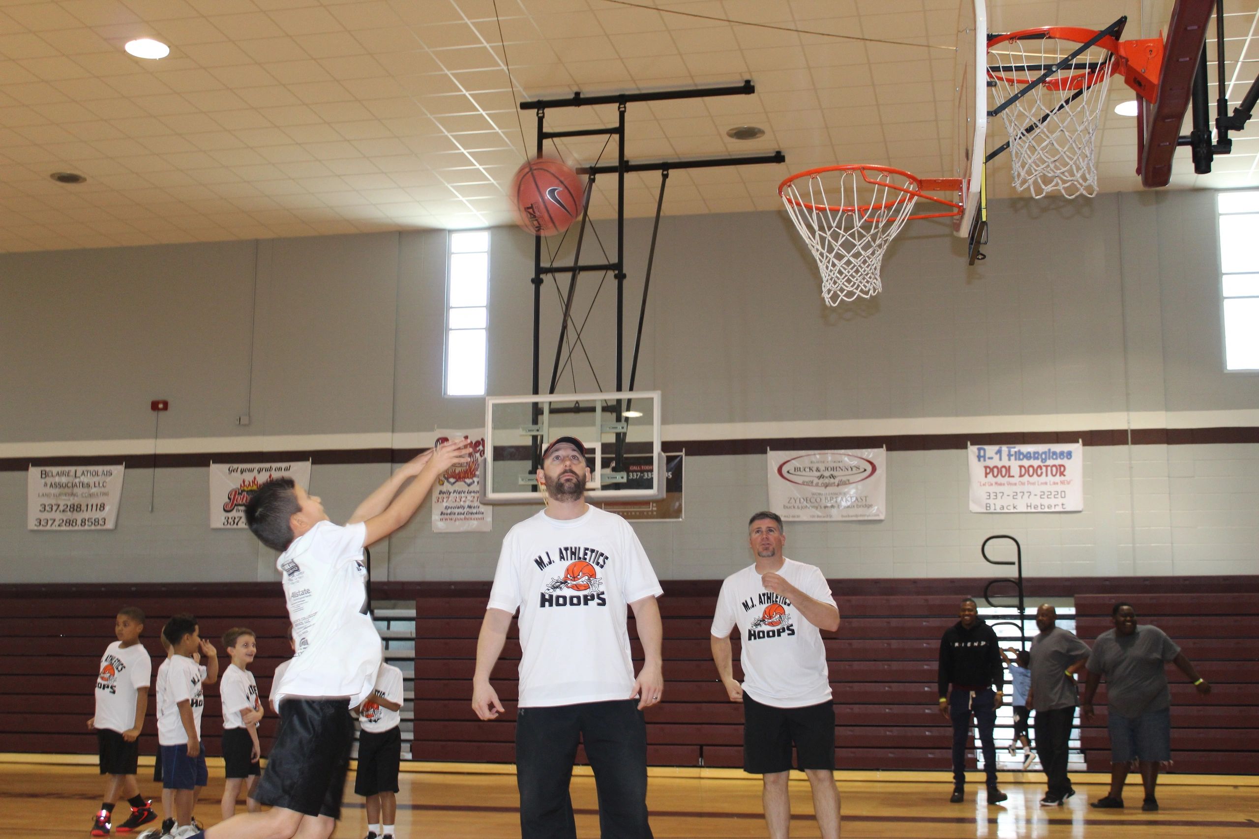 M.I. Athletics Hoops game with sponsor signs