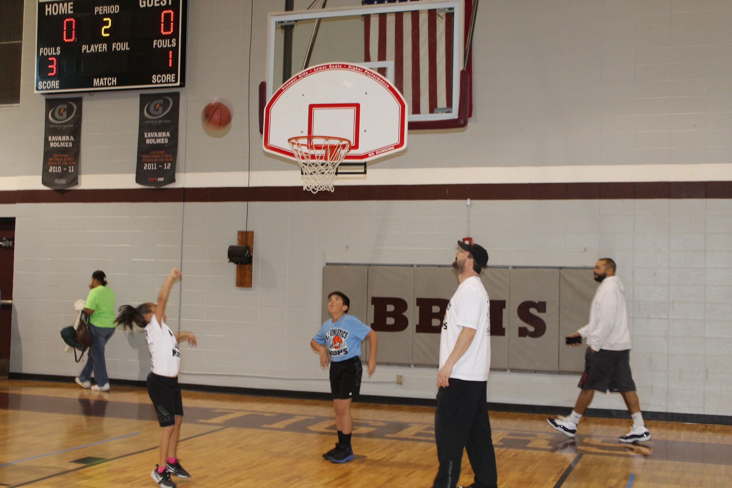 Youth basketball game with scoreboard visible