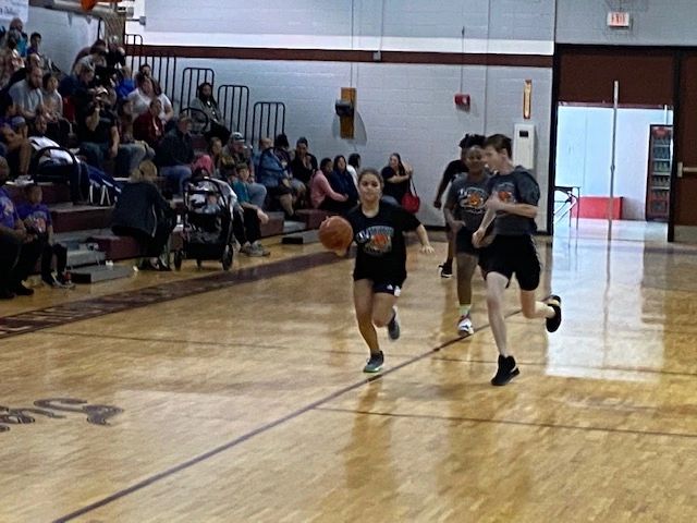 Youth basketball game with black uniforms
